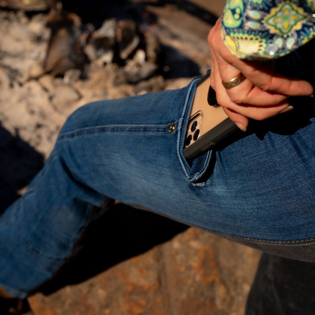 Mobile Phone Sliding into Pocket of Horse Riding Jeans