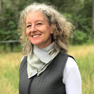 woman in ride proud neck warmer and vest