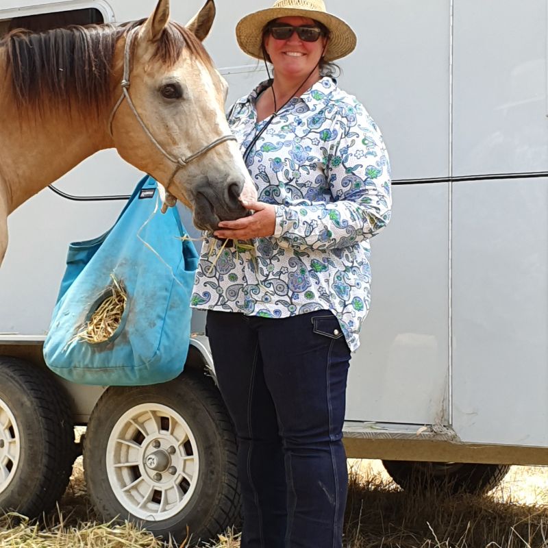 woman feeding a horse