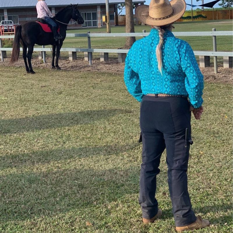woman in ride proud trainers pants