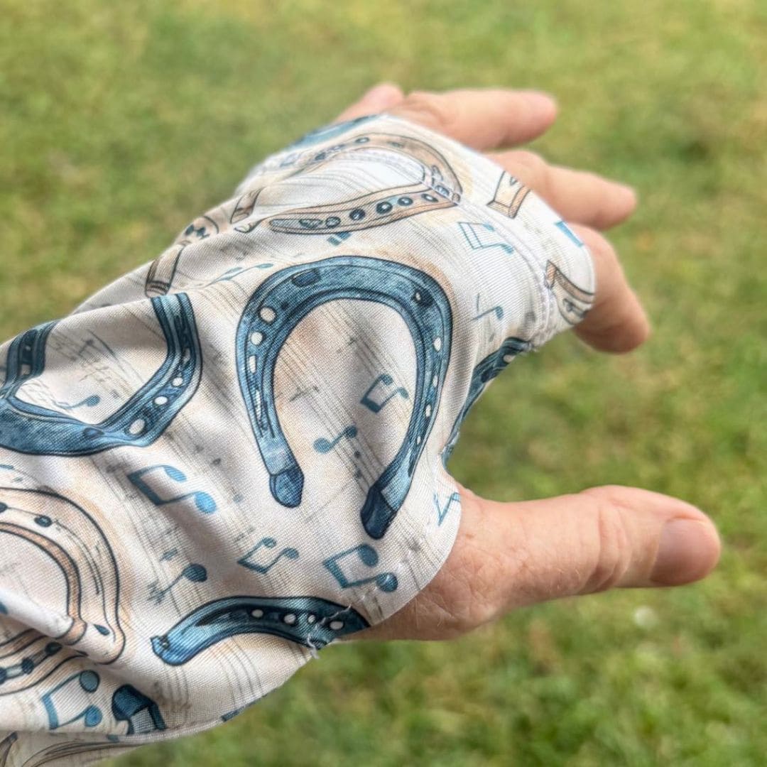 woman in horse riding shirt in horse shoe and music notes print showing thumb holes
