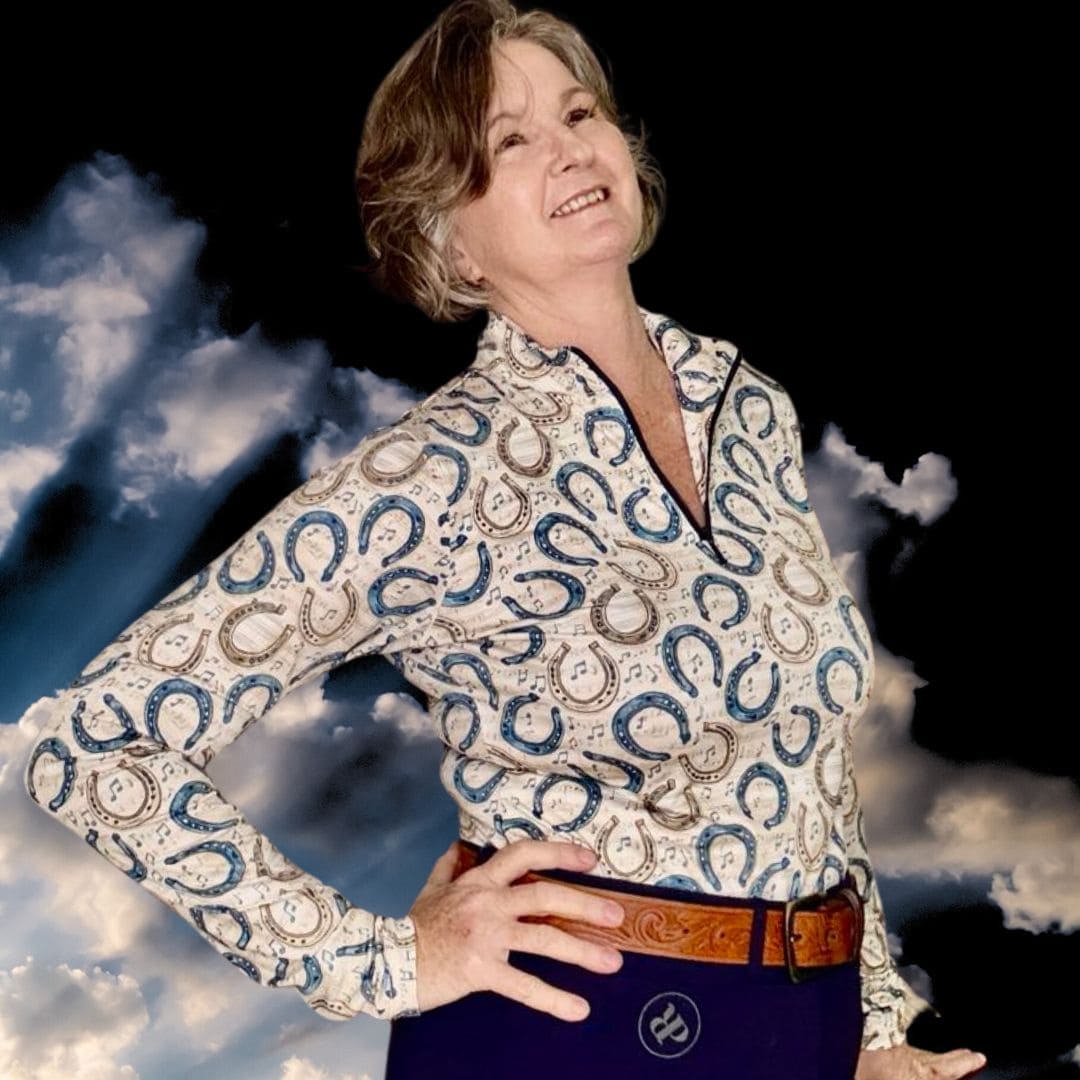 woman in horse riding shirt in horse shoe and music notes print
