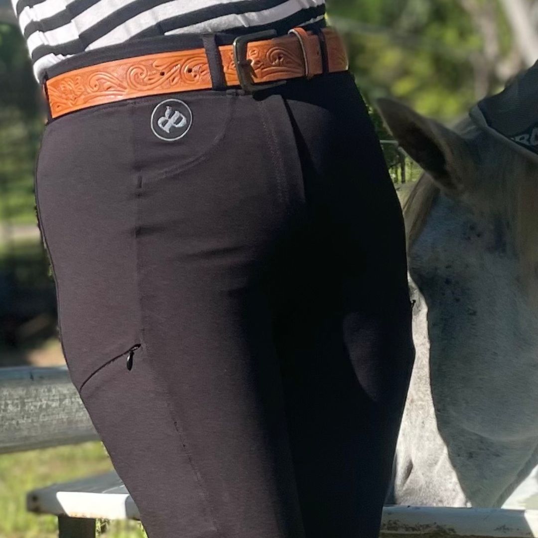 Woman wearing Bootcut Horse Riding Tightsin black with horse drinking from trough