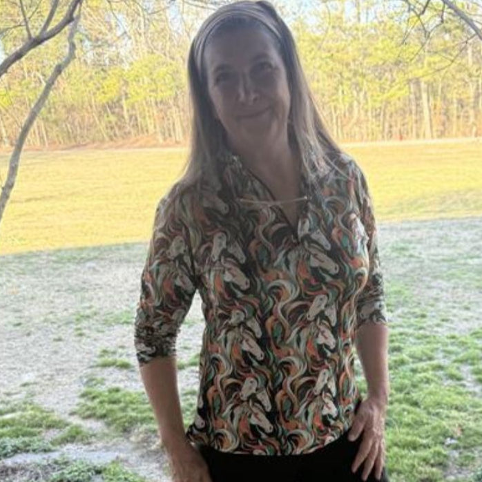 women in horse riding shirt and tights