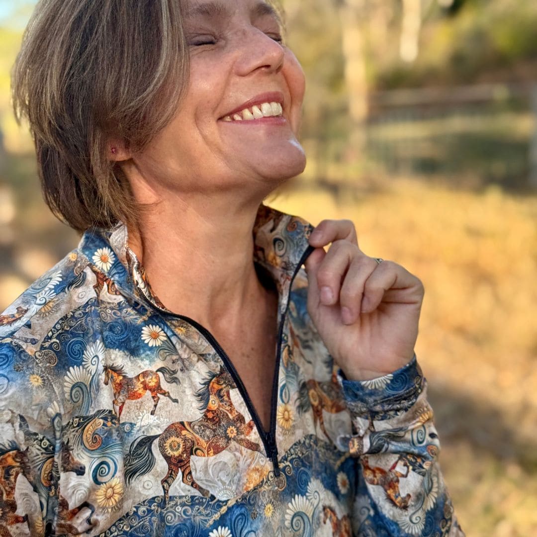 Woman wearing a horse riding patterned long-sleeve shirt in alchemy print