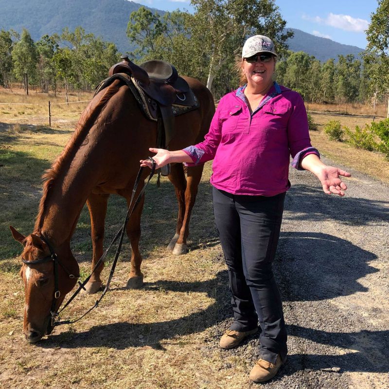 woman in pink standing with open arms
