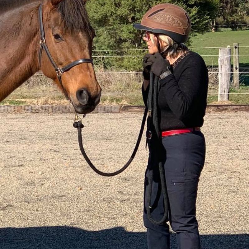 woman removing a helmet