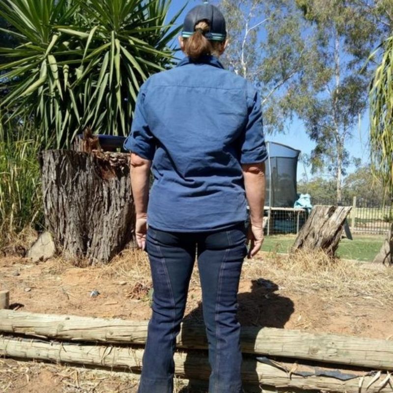 woamn standing on her horizon jeans back shot