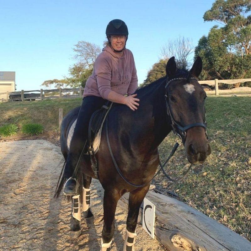 woman in equitation wearing brown hoody