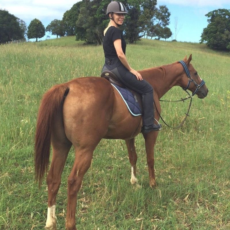 woman in equitation with helmet on