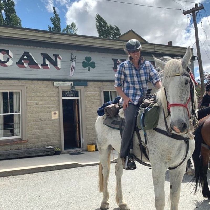 woman in equitation wearing a checkered top