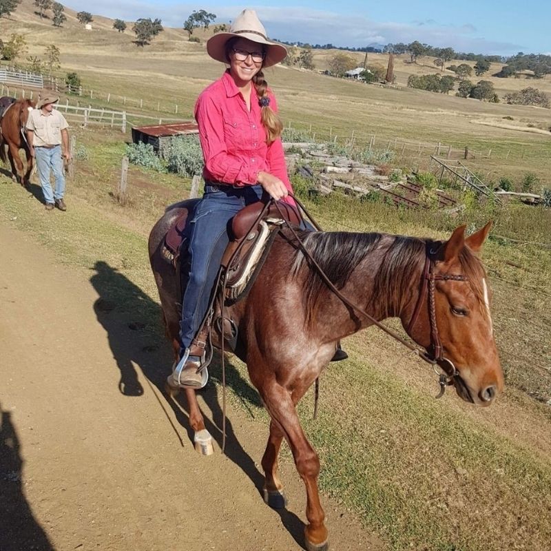 woman in her horizon jeans and wild pink top