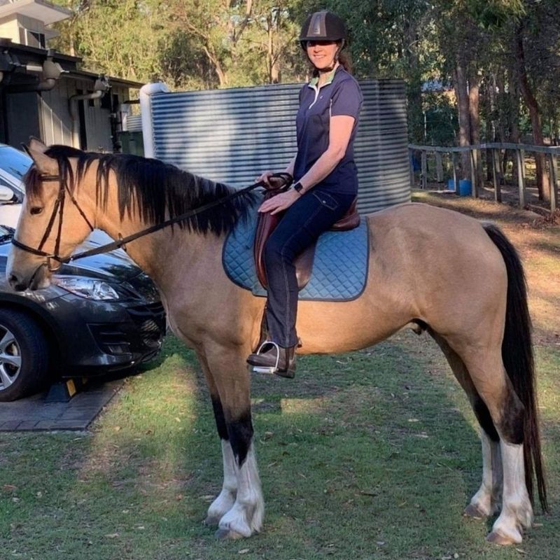 woman in her horizon jeans riding the horse
