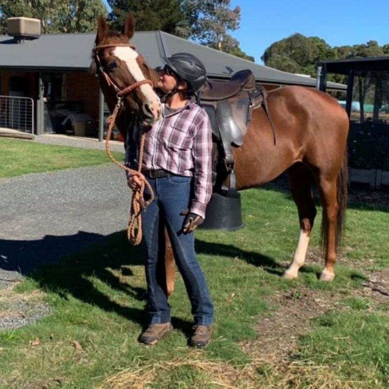 woman in horizon jeans and checkered top