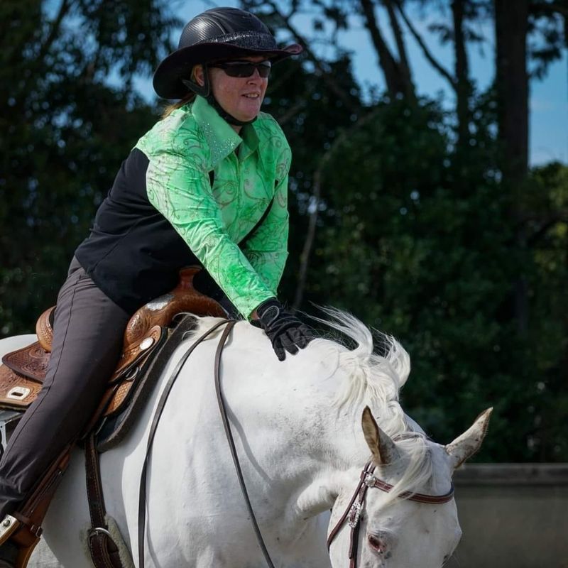 woman wearing equitation in green longsleeve top