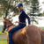 woman wearing horizon jeans riding back in the horse