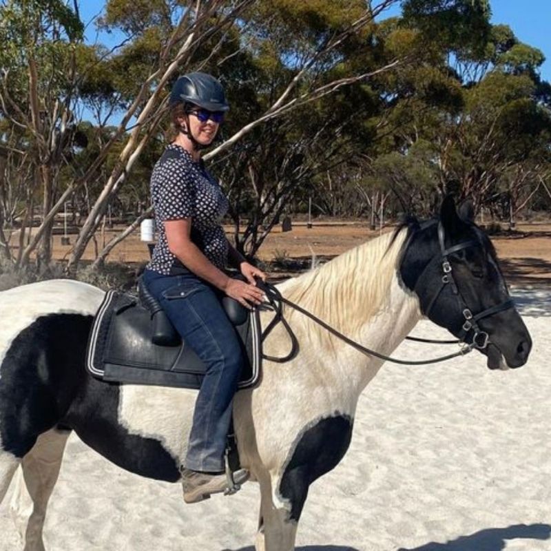 woman wearing horizon jeans riding in the horse