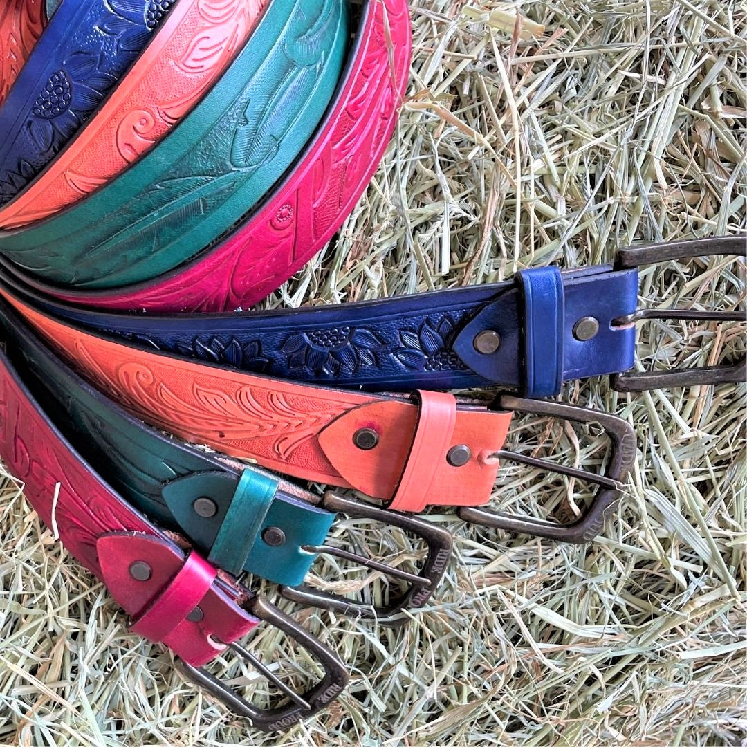 Leather belts in the colours of red, green, tan and blue